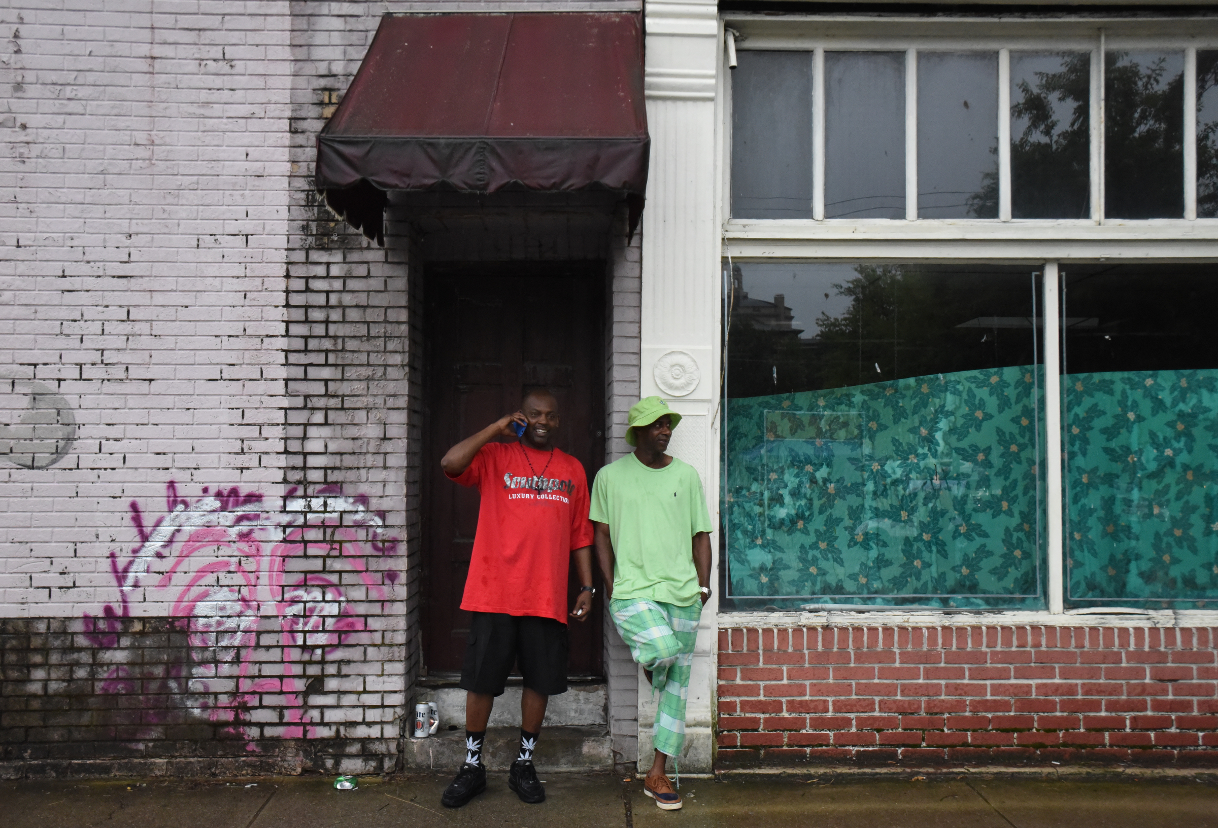Staff Photo by Angela Lewis Foster/ The Chattanooga Times Free Press- 6/08/15
Roland Jenkins, left, and Carlos Boykin stay dry under an awning as they watch the area empty Monday after heavy rains brought an early end to the Bessie Smith Strut.
