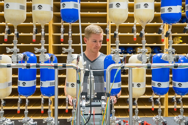 Associated Press File PhotoEric Moglia, an employee of NOAA's Cooperative Institute for Research in Environmental Sciences, prepares air sample canisters at the agency's Earth System Research Laboratory in Boulder, Colo.