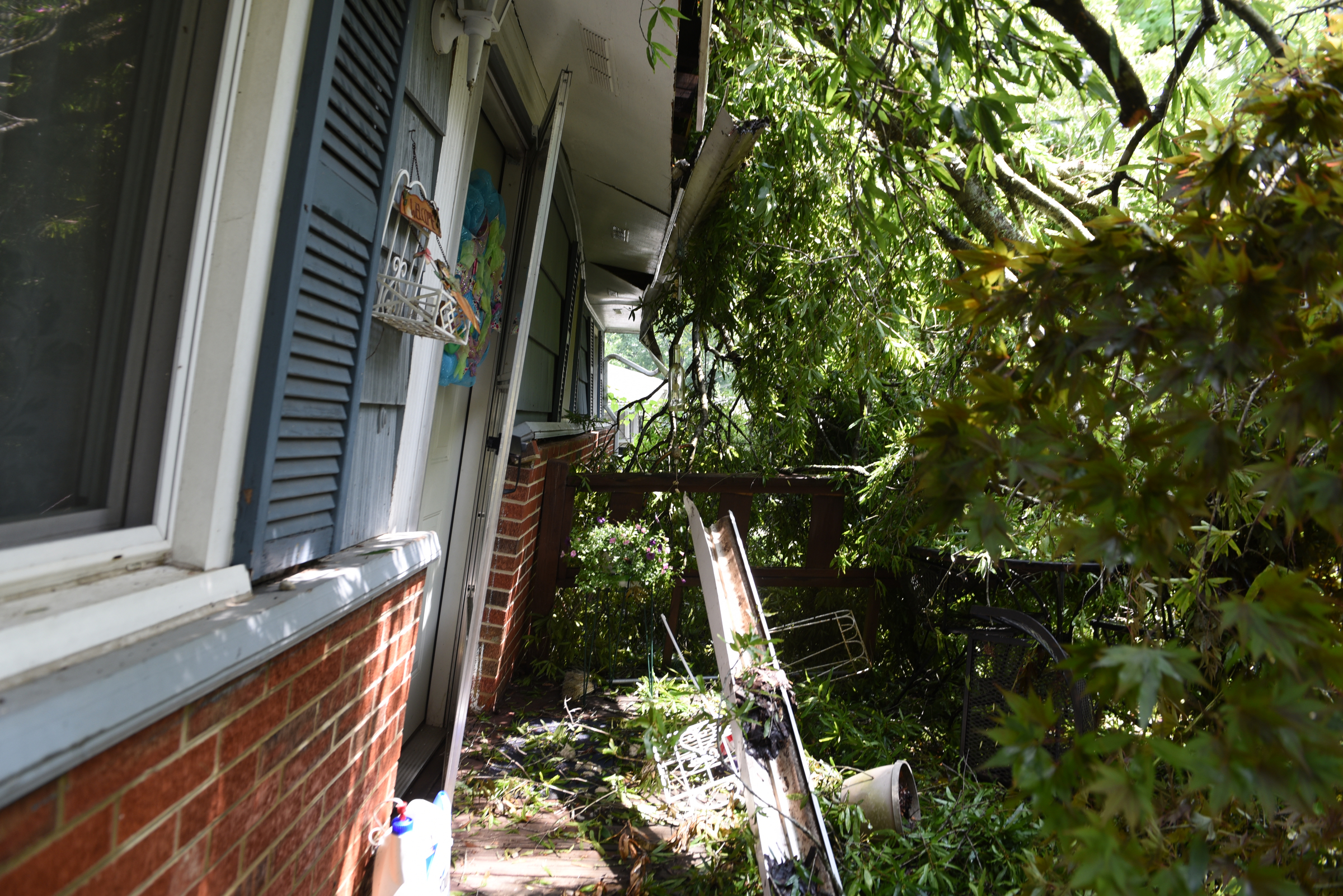 Staff photo by John Rawlston/Chattanooga Times Free Press - {iptcmonthname3 {iptcday}, 2015
Seen Tuesday, June 9, 2015, in East Ridge, Tenn., this house owned by Susan Dodson on Altamaha Street was severely damaged by falling trees during Monday night storms. The front wall of the house is leaning forward due from the fallen trees. Her son was home at the time of the storm, but he escaped injury.