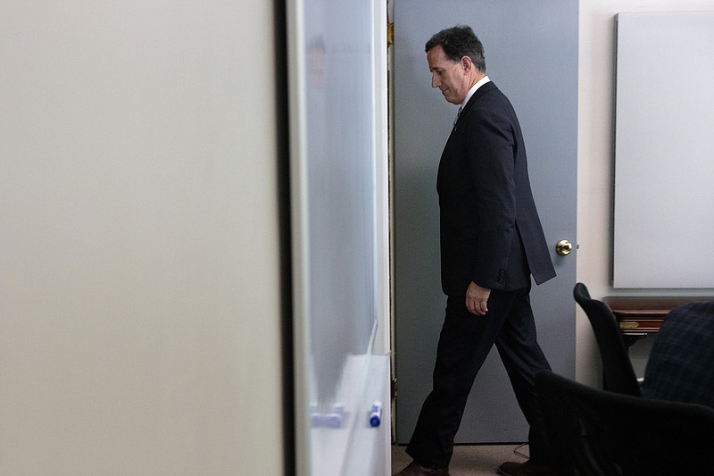 Staff photo by Doug StricklandGOP presidential hopeful Rick Santorum, the keynote speaker at the Lincoln Day Dinner in Chattanooga, leaves a news conference at Cumulus Media on Pineville Road on Wednesday afternoon.