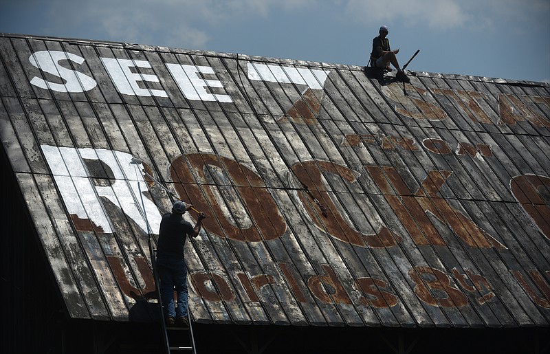 Staff Photo by Angela Lewis Foster/ The Chattanooga Times Free Press- 6/10/15
Scott Hoskins, left, and Brian Miller, with H & M Painting, paint a Rock CIty barn Wednesday in the Grassy Cove community on Highway 68 in Cumberland County.