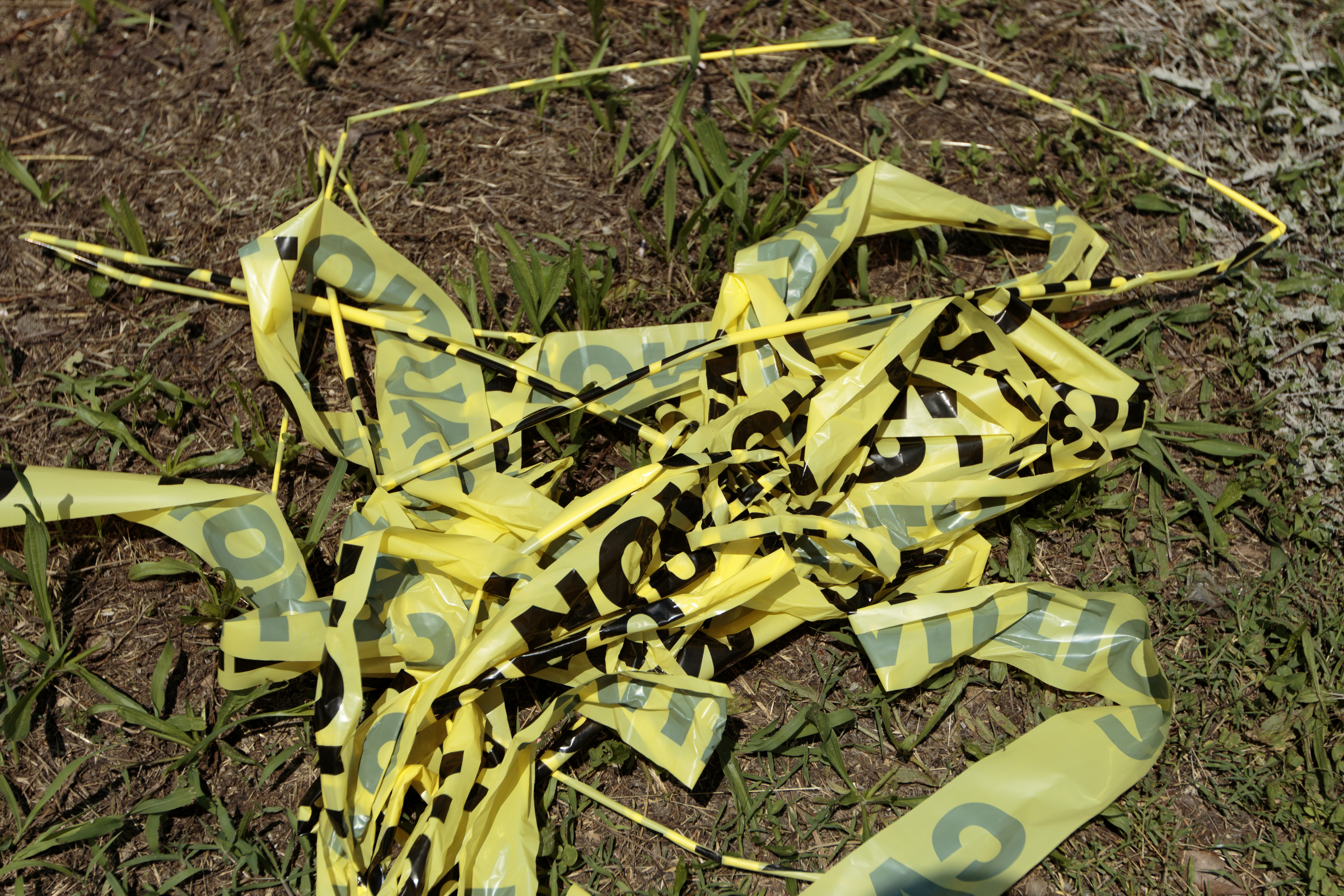 Staff photo by Doug Strickland
Caution tape torn down by Daved Senters, owner of Daved's Deli which is located at a corner where Middle Valley Road has been temporarily closed for the construction of a new Wal Mart Neighborhood Market store, is seen on the ground Wednesday, June 10, 2015, in Hixson, Tenn. The tape was blocking an exit of the gravel lot around Senters's deli.
