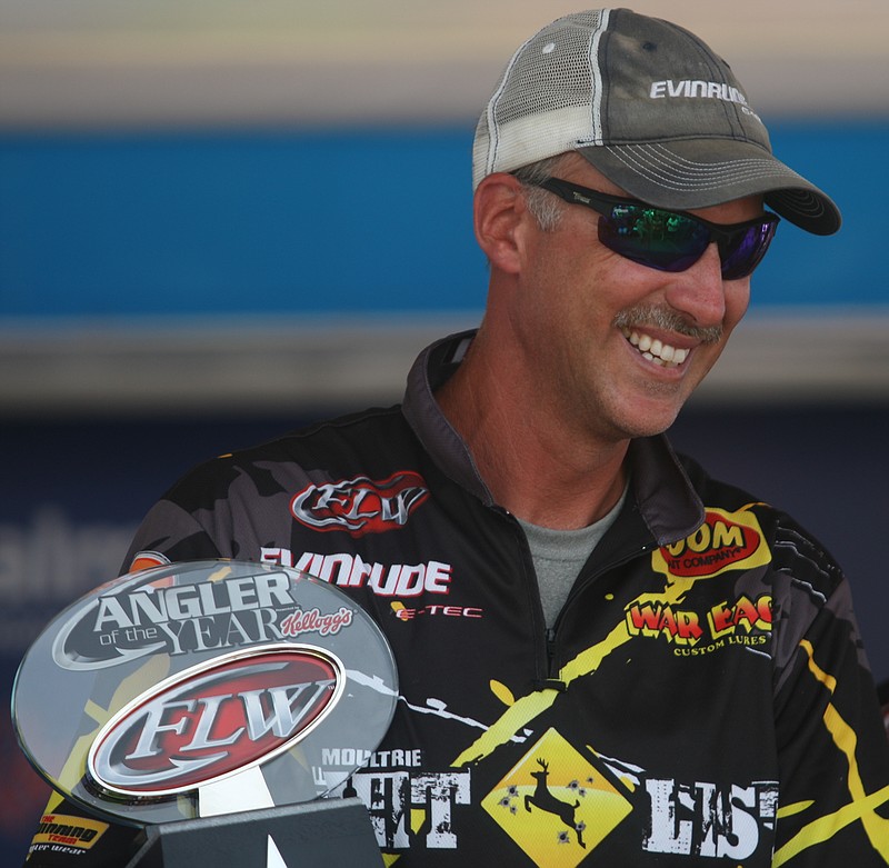 Staff File PhotoAndy Morgan smiles as he holds his FLW Angler of the Year trophy during the final weigh-in of the 2013 FLW Tour tournament at Lake Chickamauga. This year's tournament starts today and finishes Sunday, with Dayton's Morgan in the field again.