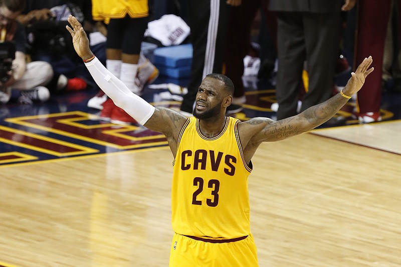 
              Cleveland Cavaliers forward LeBron James (23) urges on the crowd during the second half of Game 3 of basketball's NBA Finals against the Golden State Warriors in Cleveland, Tuesday, June 9, 2015. (AP Photo/Paul Sancya)
            