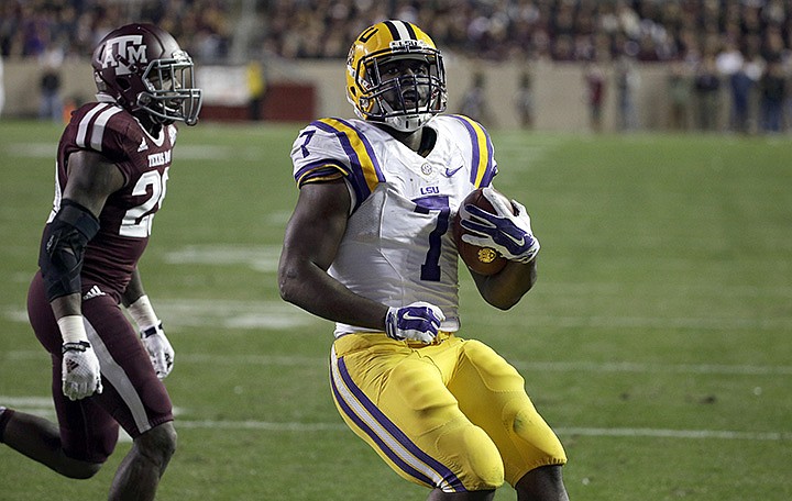 LSU running back Leonard Fournette (7) rushes for a touchdown as Texas A&M defensive back Deshazor Everett (29) defends during the second quarter of an NCAA college football game Thursday, Nov. 27, 2014, in College Station, Texas. (AP Photo/David J. Phillip)