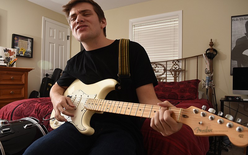 Staff photo by John Rawlston/Chattanooga Times Free Press - Feb 4, 2015
Nick Lutsko plays guitar in the bedroom of his Hixson home Wednesday, Feb. 4, 2015, where he recorded his second album, "Etc." 