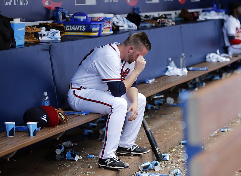 Atlanta Braves relief pitcher Brandon Cunniff sits on the bench after allowing two runs in the 11th inning of a baseball game against the San Diego Padres, Thursday, June 11, 2015, in Atlanta. San Diego won 6-4. (AP Photo/John Bazemore)  