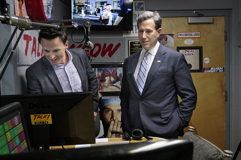 Staff photo by Doug StricklandFormer U.S. Sen. Rick Santorum, right, talks with WGOW talk show host Brian Joyce during a break in his interview at the station Wednesday.