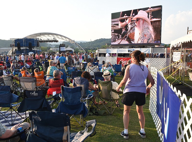 Staff photo by John Rawlston/Chattanooga Times Free Press - {iptcmonthname3 {iptcday}, 2015
Lauren Noethen (CQ) dances as she watches Leon Russell on a video screen at the Riverbend Festival on Sunday, June 7,  2015, in Chattanooga, Tenn.
