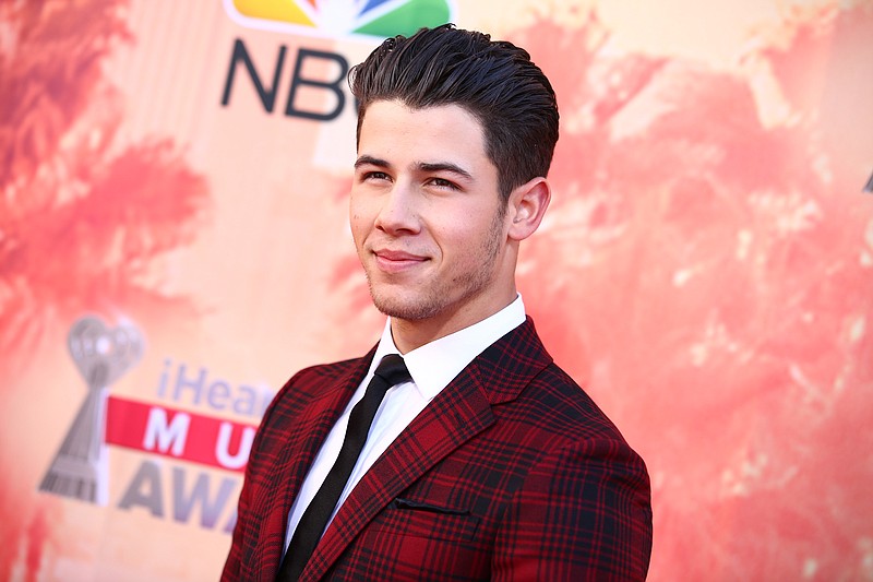 
              FILE - In this March 29, 2015 file photo, Nick Jonas arrives at the iHeartRadio Music Awards at The Shrine Auditorium, in Los Angeles. Jonas is replacing Iggy Azalea as the headline performer at a Pittsburgh gay pride event. Azalea withdrew from the Saturday, June 13, 2015, Pride in the Street concert amid criticism for making anti-gay and racist remarks on social media. (Photo by John Salangsang/Invision/AP, File)
            