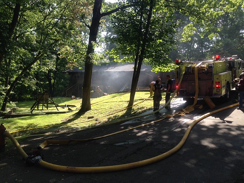Emergency personnel work to extinguish a fire in Collegedale on Friday.