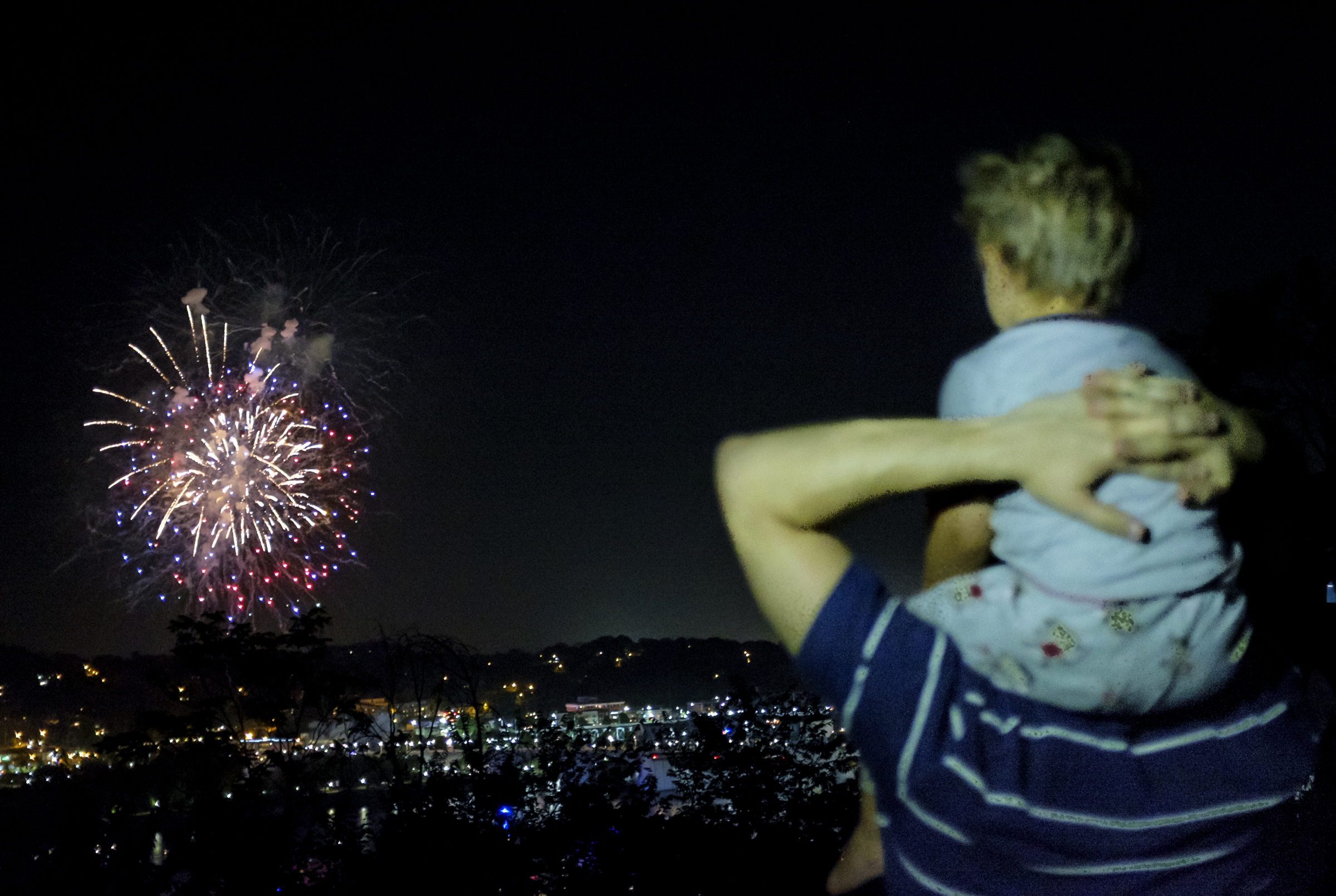 Eric Polino and his 2-year-old son, Isaiah, watch the fireworks during the final day of the Riverbend Festival on Saturday, June 13, 2015, in Chattanooga, Tenn.