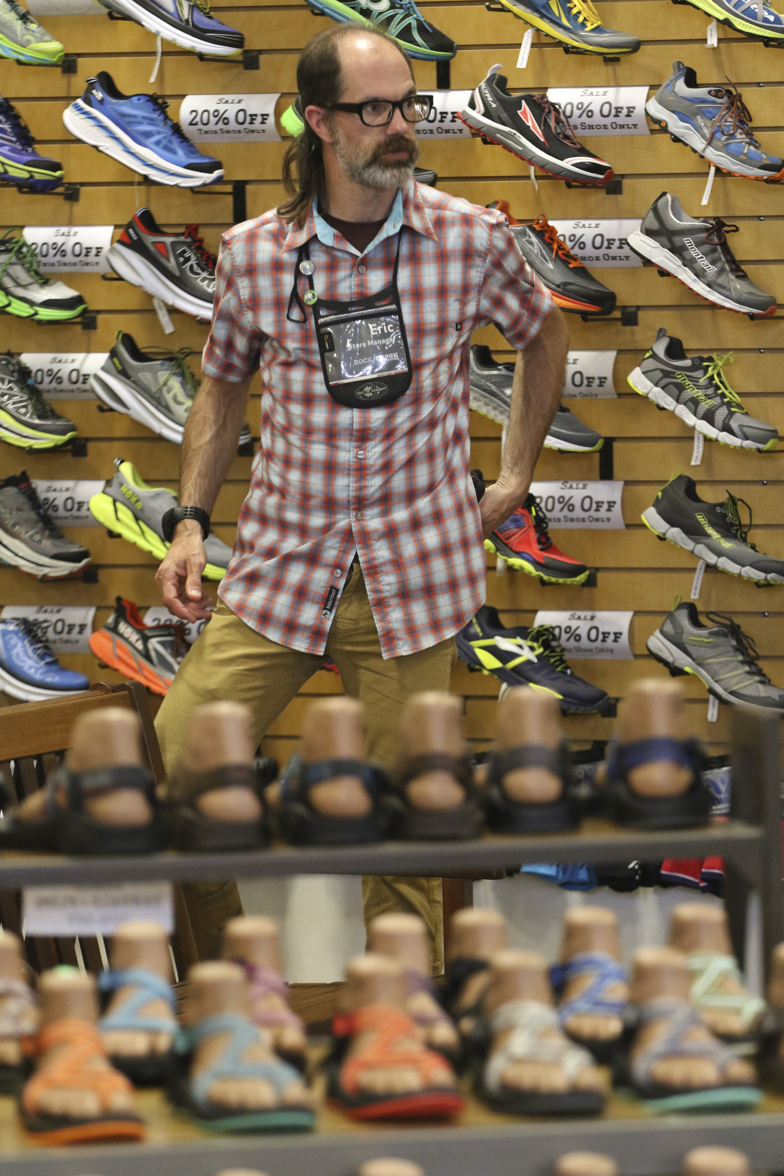 Staff Photo by Dan Henry / The Chattanooga Times Free Press- 6/9/15. Eric Loffland, store manager, waits for a customer in the shoe section of Rock Creek's flagship store in North Chattanooga on June 9, 2015.