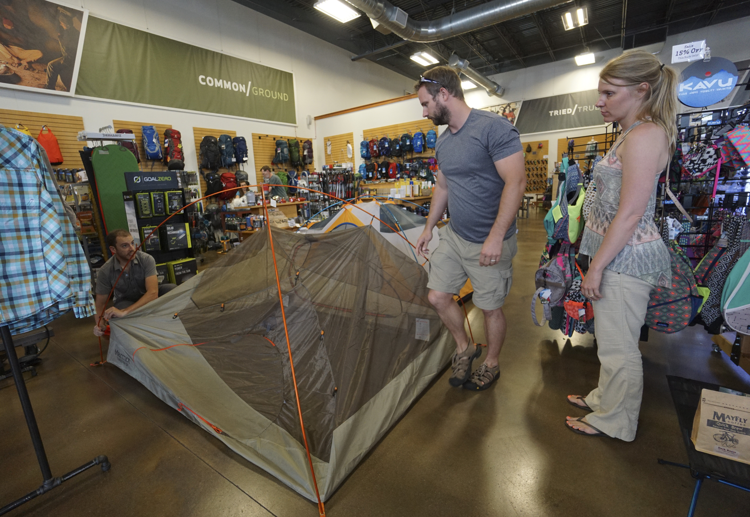 Staff Photo by Dan Henry / The Chattanooga Times Free Press- 6/9/15. Jeremy Parker, left, assists Serena and Darren Cooper demonstrating how to set up Marmot's