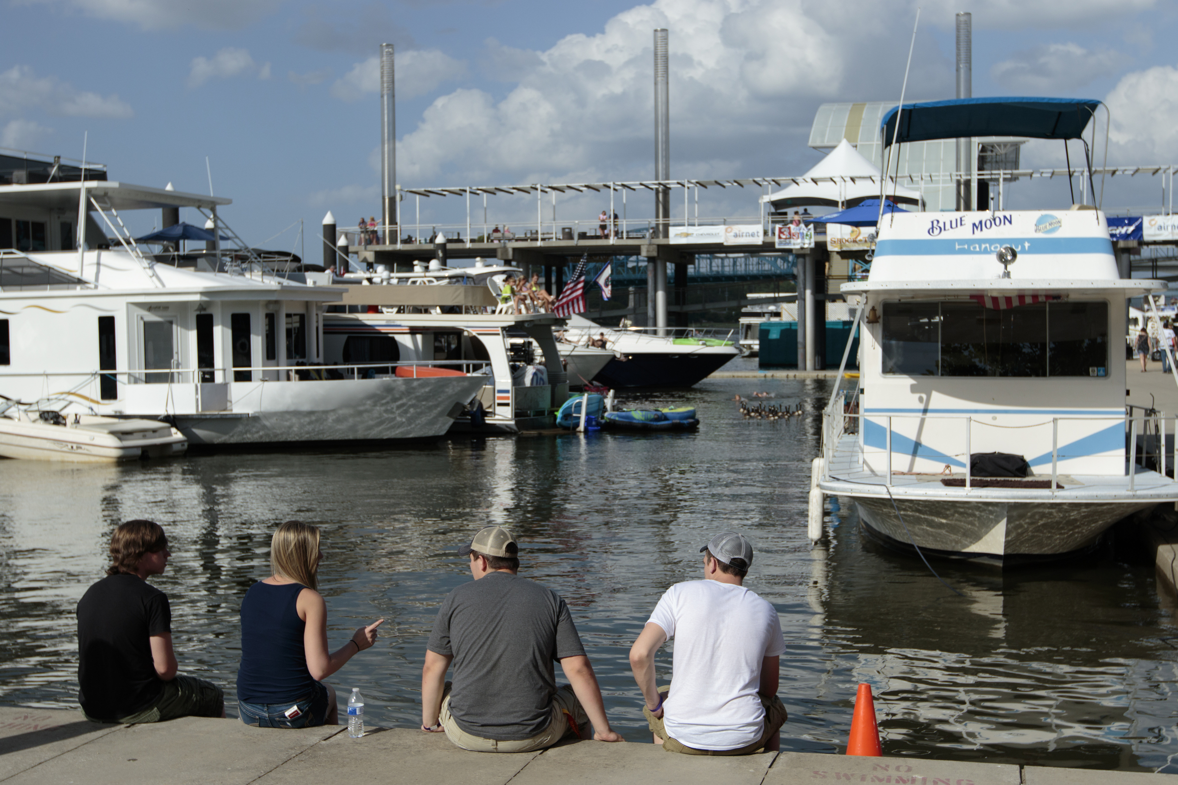 Staff photo by Doug Strickland
People sit at the edge of Ross's Landing to dip their feet in the Tennessee River during the final day of the Riverbend Festival on Saturday, June 13, 2015, in Chattanooga, Tenn. Headliner Stone Temple Pilots closed the festival.