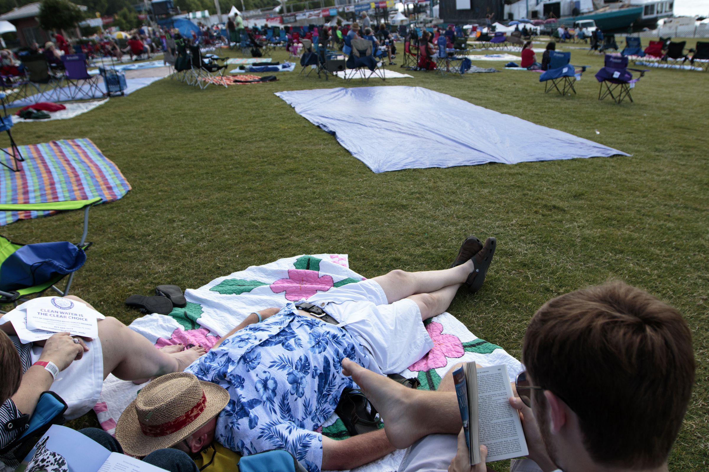 Staff photo by Doug Strickland
Jay Babb shades his face from the sun as he relaxes with his family during the final day of the Riverbend Festival on Saturday, June 13, 2015, in Chattanooga, Tenn. Headliner Stone Temple Pilots closed the festival.