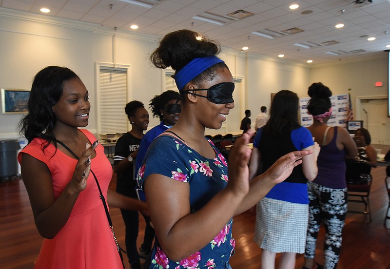 Staff Photo by Angela Lewis FosterAdrienne Hall, left, operates "robot" Valerie Paris during a program Friday at United Way for students who were chosen for their leadership qualities.