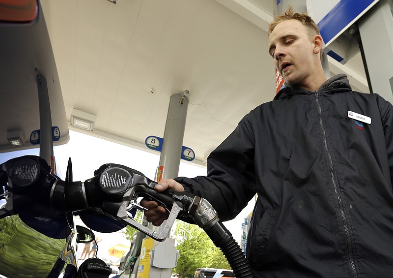 James Lewis pumps gas at a station in this file photo.