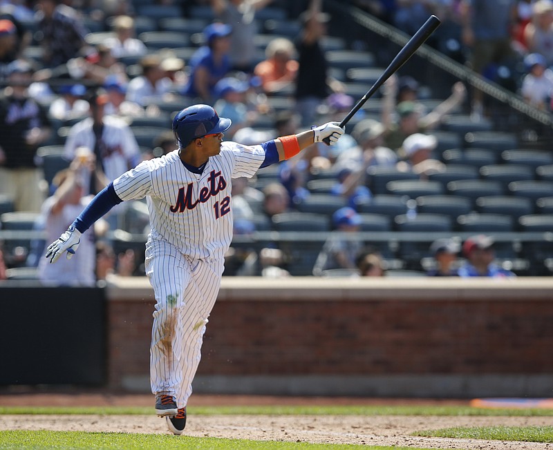 New York Mets Juan Lagares (12) reacts after hitting a sixth-inning, three-run, home run in his game against the Atlanta Braves in New York, Sunday, June 14, 2015. 