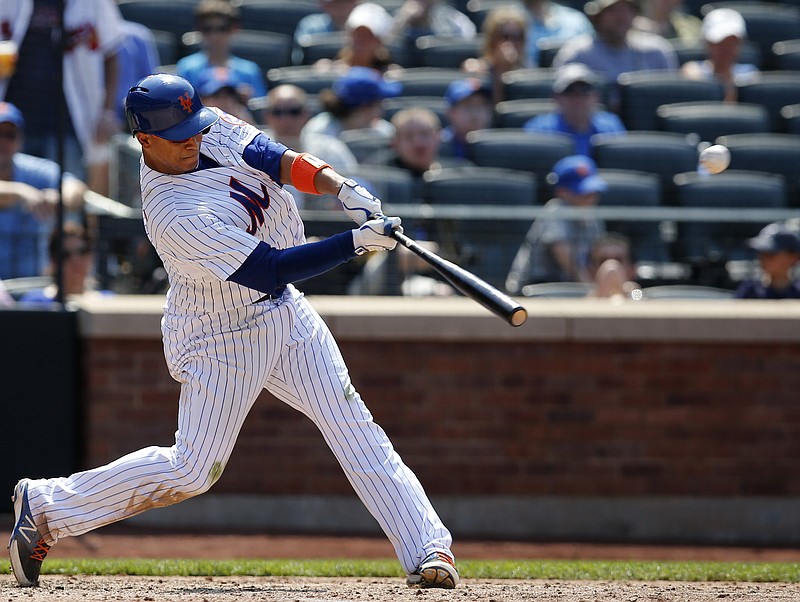 New York Mets Juan Lagares (12) hits a sixth-inning, three-run home run in his game against the Atlanta Braves in New York, Sunday, June 14, 2015.