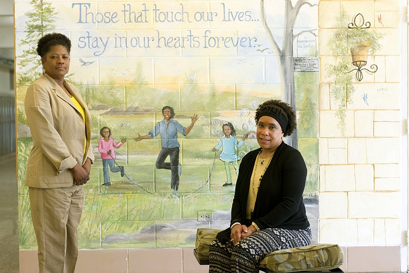 
              In this photo taken on Tuesday, May 12, 2015, principals Sherry Hensley of Chilhowee Intermediate, left, and Sydney Upton of Sunnyview Primary are pictured with a memorial to school bus crash victims in Knoxville, Tenn. The two educators have talked for the first time about how they and their school communities have coped in the wake of the collision that killed students Zykia Burns, 6, and 7-year-old Seraya Glasper, and one of the school’s instruction aides, Kimberly Riddle, and injured 27 other students. (Saul Young/Knoxville News Sentinel, via AP)
            