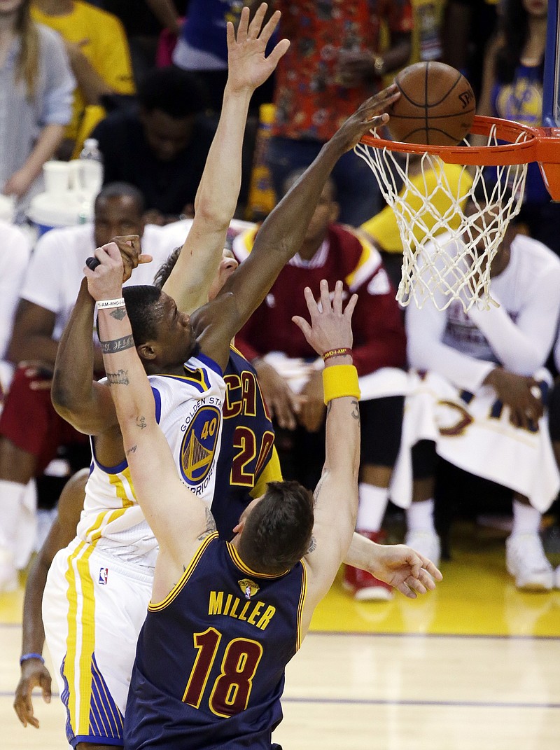 Golden State Warriors forward Harrison Barnes, top, dunks against Cleveland Cavaliers guard Mike Miller (18) during their Game 5 of basketball's NBA Finals in Oakland, Calif., Sunday, June 14, 2015.