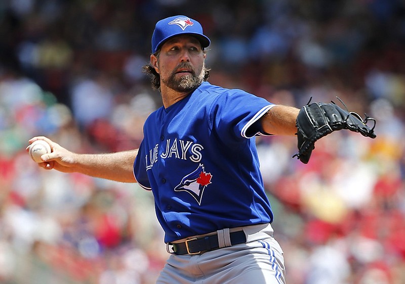 Toronto Blue Jays starting pitcher R.A. Dickey pitches against the Boston Red Sox during the first inning of a baseball game at Fenway Park in Boston Saturday, June 13, 2015. (AP Photo/Winslow Townson)