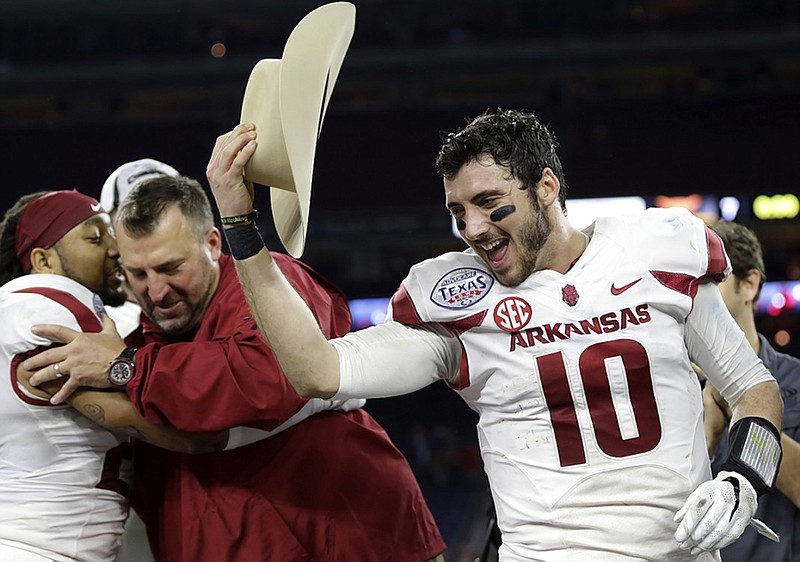 Arkansas quarterback Brandon Allen (10) tips a cowboy hat to teammates after winning the Most Valuable Player award in the Texas Bowl NCAA college football game against Texas Monday, Dec. 29, 2014, in Houston. Arkansas won 31-7. (AP Photo/David J. Phillip)