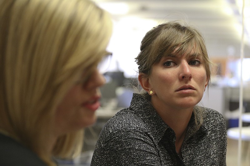 Staff Photo by Dan Henry / The Chattanooga Times Free Press- 6/16/15. Emory Evans, right, listens as Stacey Crisp speaks about a new Regus facility that will be built in the Tennessee Valley. 