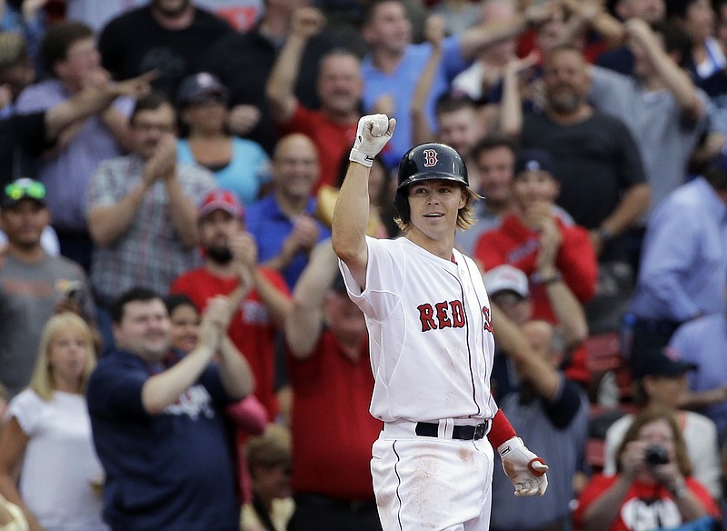 Boston Red Sox's Brock Holt gestures after hitting a triple in his game against the Atlanta Braves at Fenway Park on Tuesday, June 16, 2015, in Boston. Holt hit for the cycle (a single, double, triple and homer) in the baseball game. 