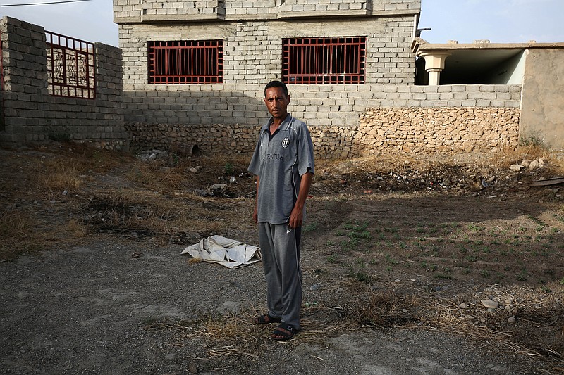 
              In this May 26, 2015 photo, Bilal Abdullah poses for a portrait in the village of Eski Mosul in northern Iraq, nearly a year after Islamic State militants took over the village. In the Islamic State's realm, a document testifying that one has "repented" from a heretical past must be carried at all times and it can mean the difference between life and death. Abdullah learned that not long after the extremists took over his home village. (AP Photo/Bram Janssen)
            