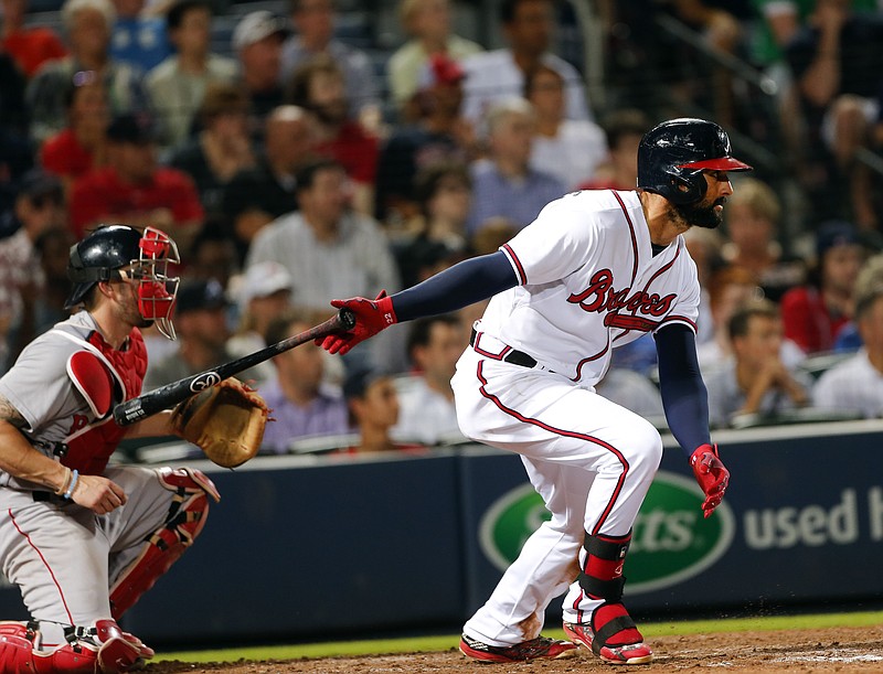 Atlanta Braves right fielder Nick Markakis (22) puts the Braves ahead with an RBI-base hit as Boston Red Sox catcher Blake Swihart (23) looks on in their game Wednesday, June 17, 2015, in Atlanta.