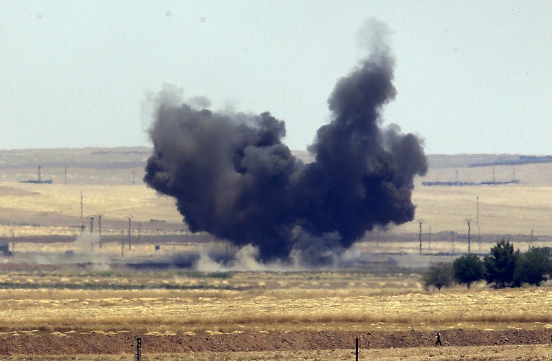 In this photo taken from the Turkish side of the border between Turkey and Syria, in Akcakale, Sanliurfa province, southeastern Turkey, smoke from a US-led airstrike rises over the outskirts of Tal Abyad, Syria last Sunday. Syrian Kurdish fighters closed in on the outskirts of a strategic Islamic State-held town on the Turkish border Sunday, Kurdish officials and an activist group said, potentially cutting off a key supply line for the extremists' nearby de facto capital. Taking Tal Abyad would mean the group wouldn't have a direct route to bring in new foreign militants or supplies.