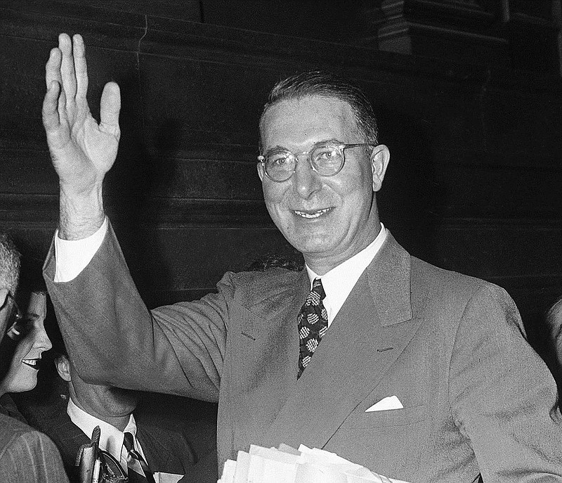 Sen. Estes Kefauver (D-Tenn.), chairman of the Senate Crime investigating committee, waves as he leaves hearing room in Federal Courthouse, New York on March 21, 1951 at completion of the New York hearings of the committee. (AP Photo/PL)