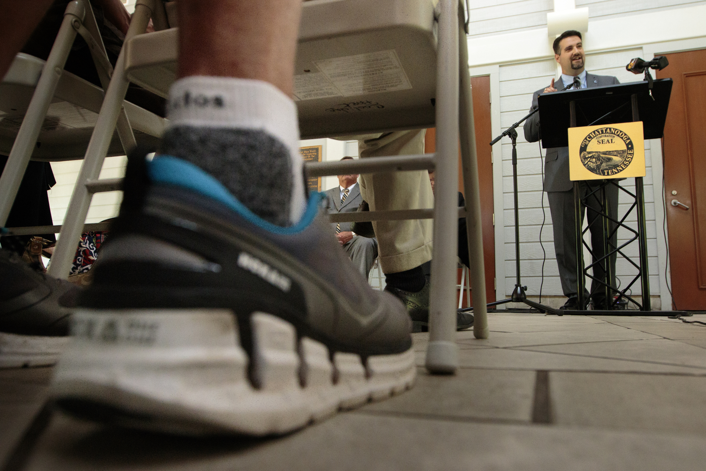 Staff photo by Doug Strickland
A spectator wears running shoes as Chattanooga Sports Committee President Tim Morgan talks about the creation of the new Chattanooga Marathon at a news conference Thursday, June 18, 2015, at Coolidge Park in Chattanooga, Tenn. The marathon is set to take place March 4-6 of 2016.