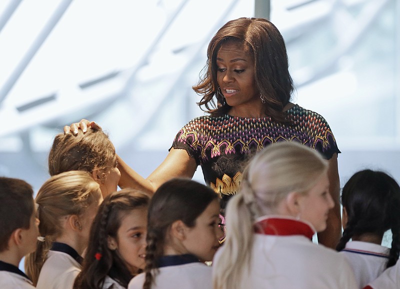 U.S. first lady Michelle Obama meets Italian schoolchildren during her visit at the Italian pavilion at the 2015 Expo in Rho, near Milan, Italy, Thursday, June 18, 2015. Mrs. Obama is leading a presidential delegation Thursday to the world's fair, organized around issues concerning food and nutrition, which dovetails with the U.S. first lady's "Let's Move" initiative to fight childhood obesity through diet and exercise.
            