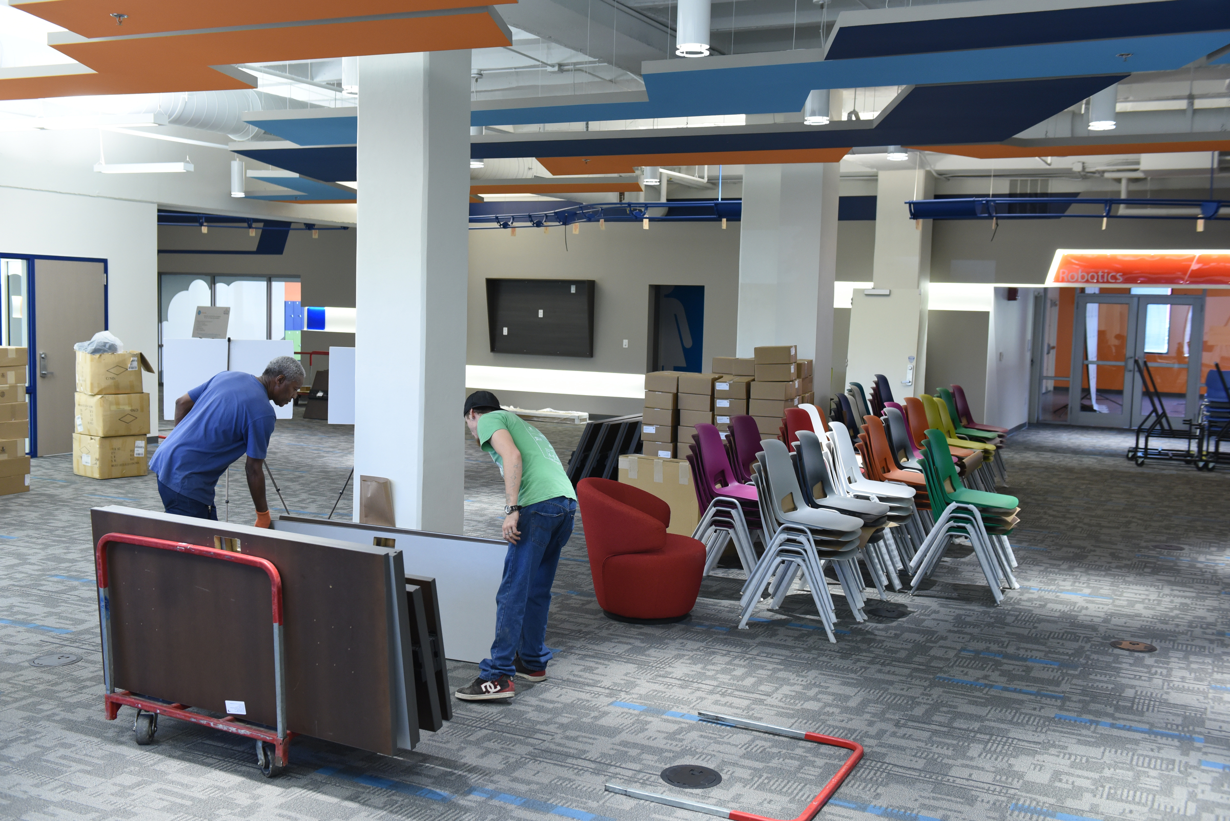 Staff photo by John RawlstonOCI employees Anthony Slay, left, and Allen Youngs unload furnishings at TechTown.