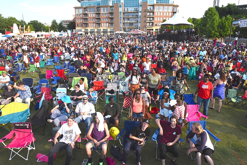 Staff photo by John Rawlston2015 Attendees watch behind the reserved seating area as Doug E. Fresh performs the early show on the Coca Cola Stage at the Riverbend Festival on Wednesday, June 10, 2015.