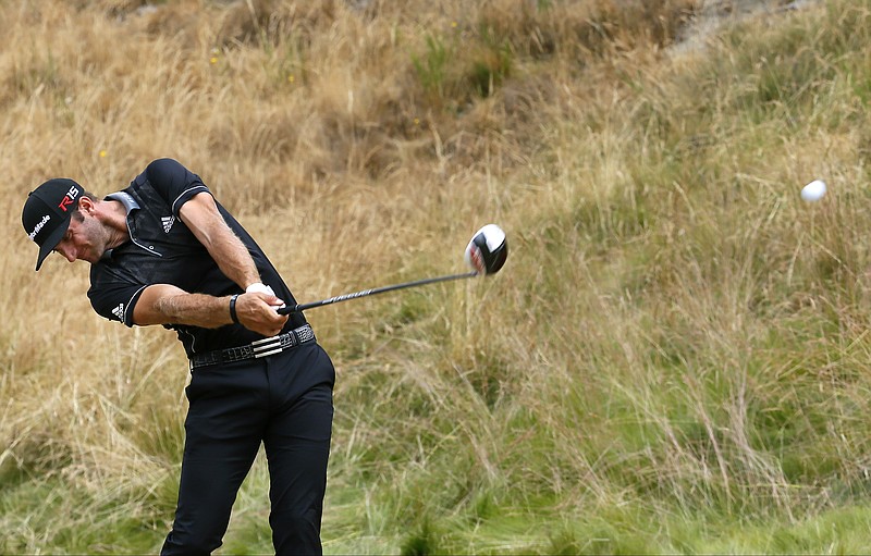 Dustin Johnson hits his tee shot on the eighth hole during the first round of the U.S. Open golf tournament at Chambers Bay on Thursday, June 18, 2015 in University Place, Wash.