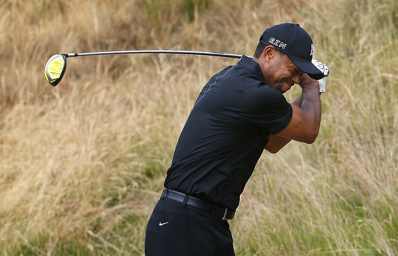 Tiger Woods reacts to his tee shot on the eighth hole during the first round of the U.S. Open golf tournament at Chambers Bay on Thursday, June 18, 2015 in University Place, Wash.