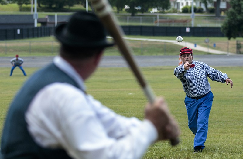 Staff photo by Doug Strickland
Lightfoot player Deaurhan Crawford pitches to Stewart's Creek player Skeeter Wells during their Vintage Base Ball game Saturday, June 20, 2015, in Fort Oglethorpe, Ga. Vintage baseball is played using Civil War era rules, and players wear period attire and use only equipment which would have been available at the time.