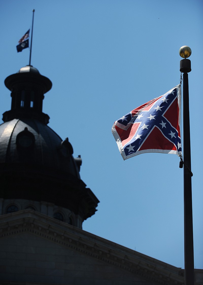 
              The Confederate flag flies near the South Carolina Statehouse, Friday, June 19, 2015, in Columbia, S.C. Tensions over the Confederate flag flying in the shadow of South Carolina’s Capitol rose this week in the wake of the killings of nine people at a black church in Charleston, S.C. (AP Photo/Rainier Ehrhardt)
            