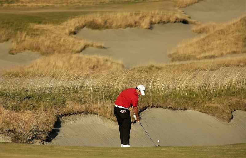 Patrick Reed hits from the fairway on the 18th hole during the second round of the U.S. Open golf tournament at Chambers Bay on Friday, June 19, 2015 in University Place, Wash.