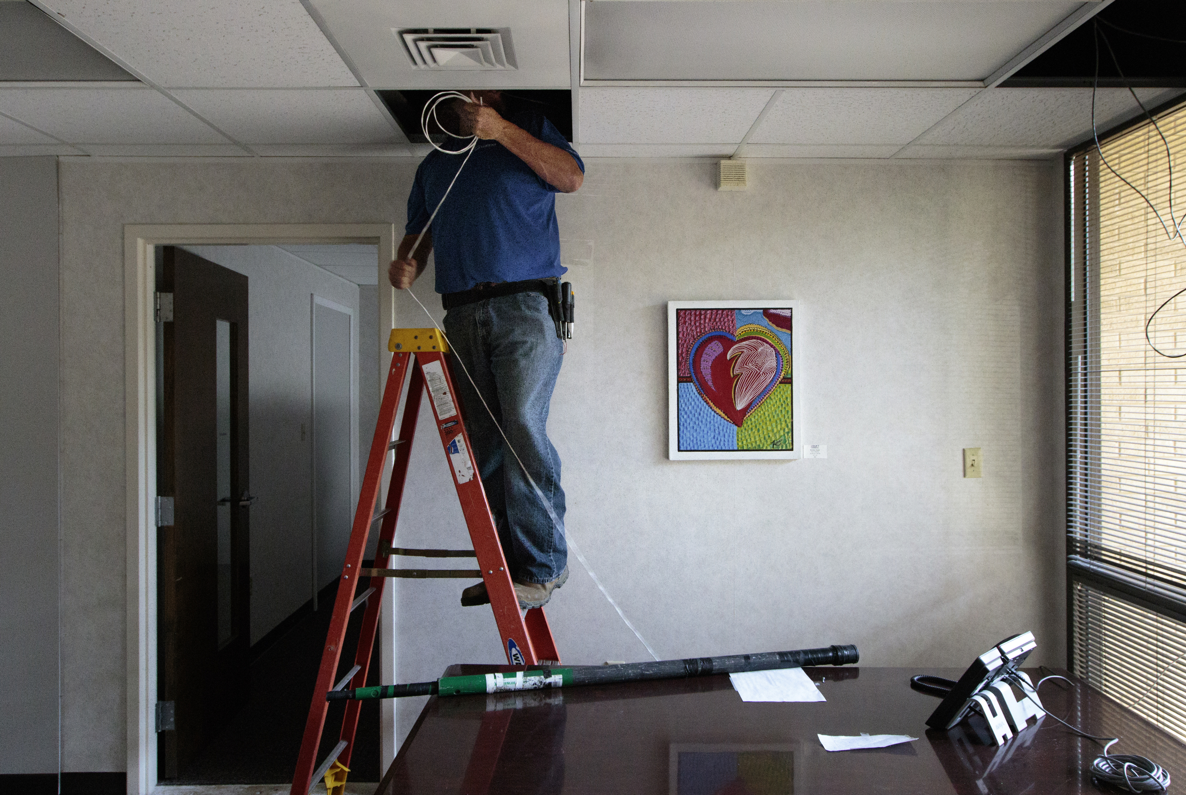 Staff photo by Doug Strickland
Dale Brewster with Gallaher & Associates works to install a security system Wednesday, June 17, 2015, at the Family Justice Center in Chattanooga, Tenn. The center is scheduled to launch July 1st.