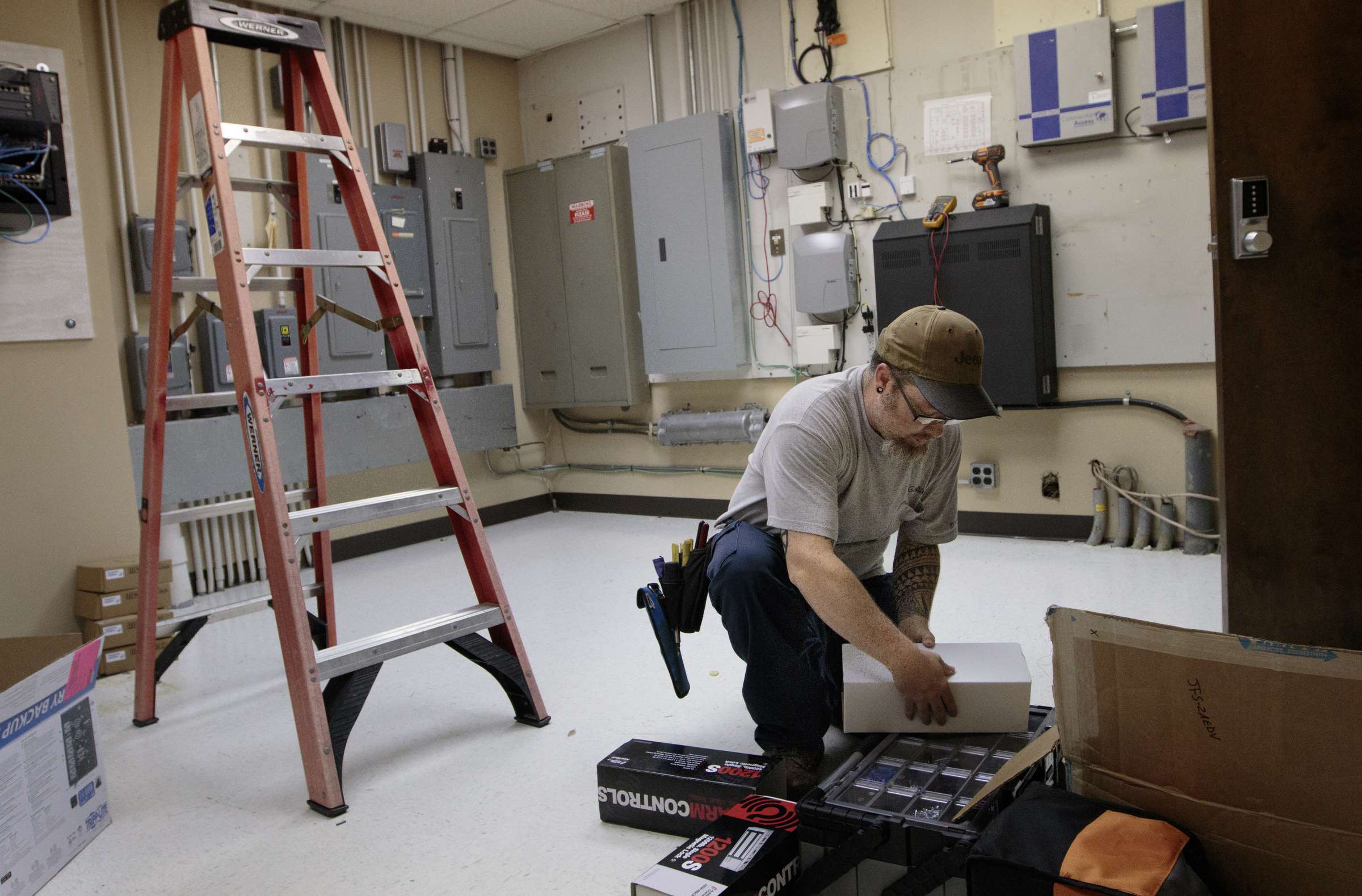 Staff photo by Doug Strickland
Marc Benton with Gallaher & Associates works to install a security system Wednesday, June 17, 2015, at the Family Justice Center in Chattanooga, Tenn. The center is scheduled to launch July 1st.