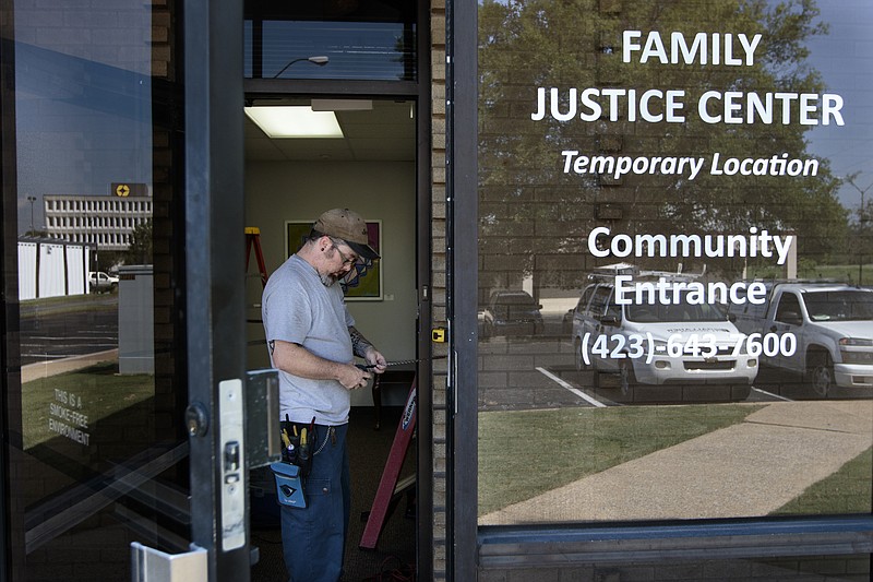 Staff photo by Doug Strickland
Marc Benton with Gallaher & Associates works to install a security system Wednesday, June 17, 2015, at the Family Justice Center in Chattanooga, Tenn. The center is scheduled to launch July 1st.