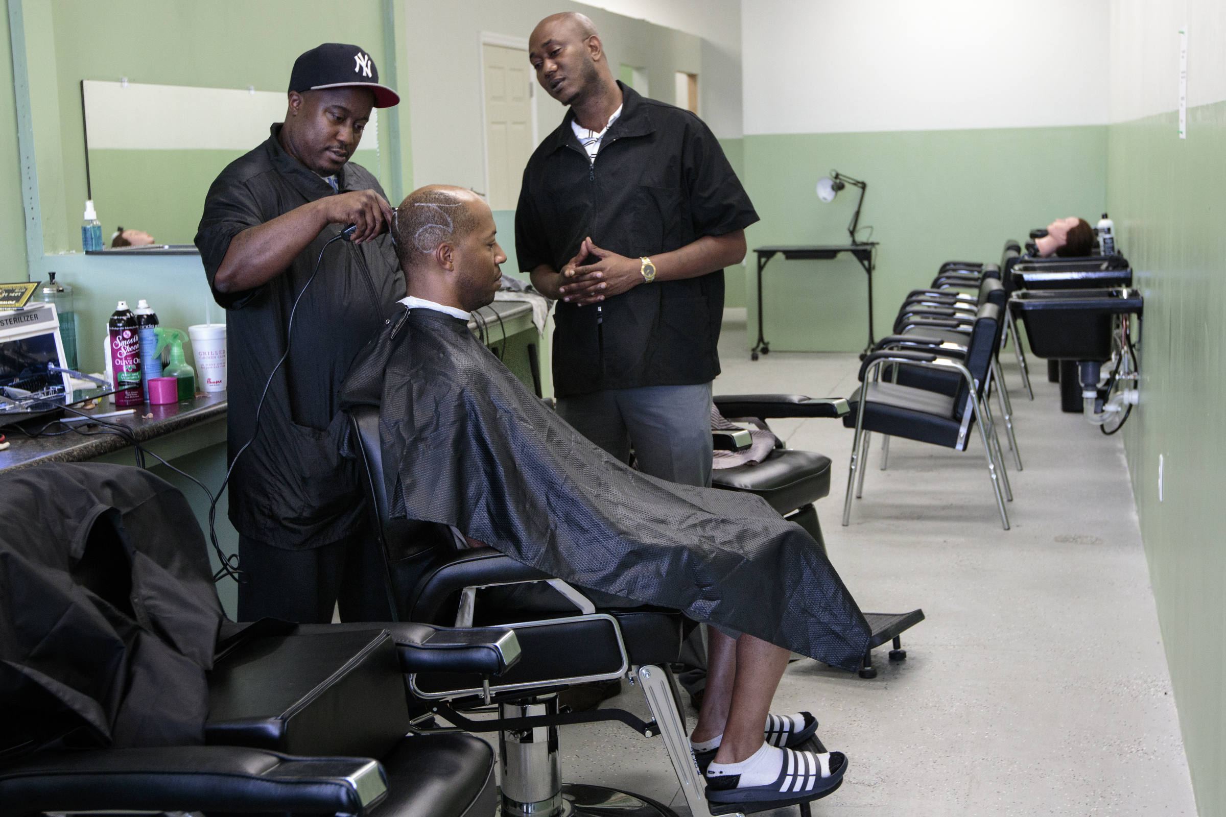 Staff photo by Doug Strickland
Tim Baker, right, watches as Thomas Evans, left, cuts Jumaane Lanier's hair Wednesday, June 17, 2015, at Baker's Barber College in Chattanooga, Tenn. Evans has been training at the school since Baker opened the barber college at the beginning of May.