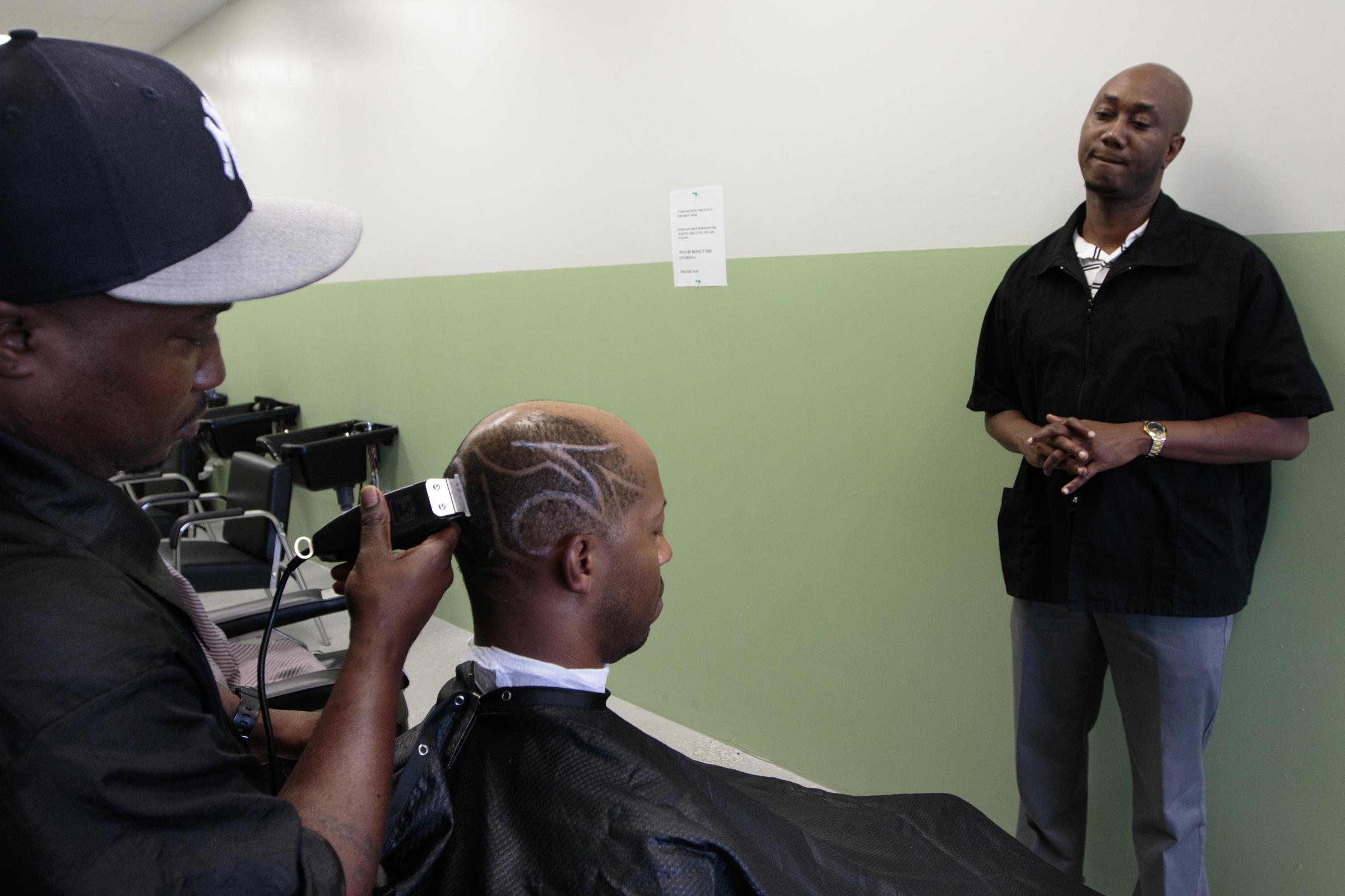 Staff photo by Doug Strickland
Tim Baker, right, watches as Thomas Evans, left, cuts Jumaane Lanier's hair Wednesday, June 17, 2015, at Baker's Barber College in Chattanooga, Tenn. Evans has been training at the school since Baker opened the barber college at the beginning of May.
