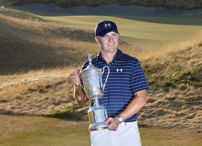 Jordan Spieth holds up the trophy after winning the final round of the U.S. Open golf tournament at Chambers Bay on Sunday, June 21, 2015, in University Place, Wash.