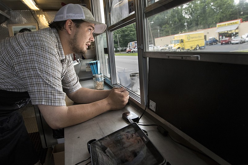Owner Ray Kazlaskia takes a customer's order inside the Double Barrel BBQ food truck Tuesday, June 9, 2015, in front of the former Pepperjack's Restaurant in Signal Mountain, Tenn. Kazlaskia has bought the restaurant and is renovating it to open as The Double Barrel on July 1st.